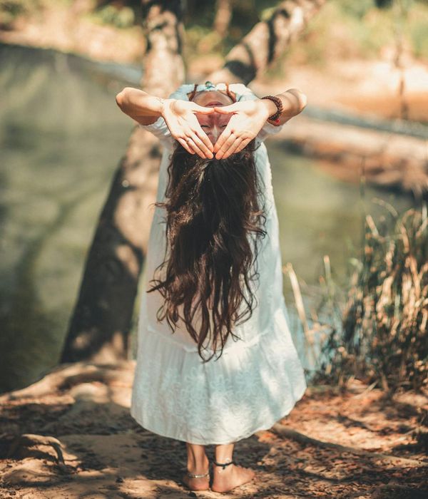Woman feeling serene and balanced in a bright, calm environment.